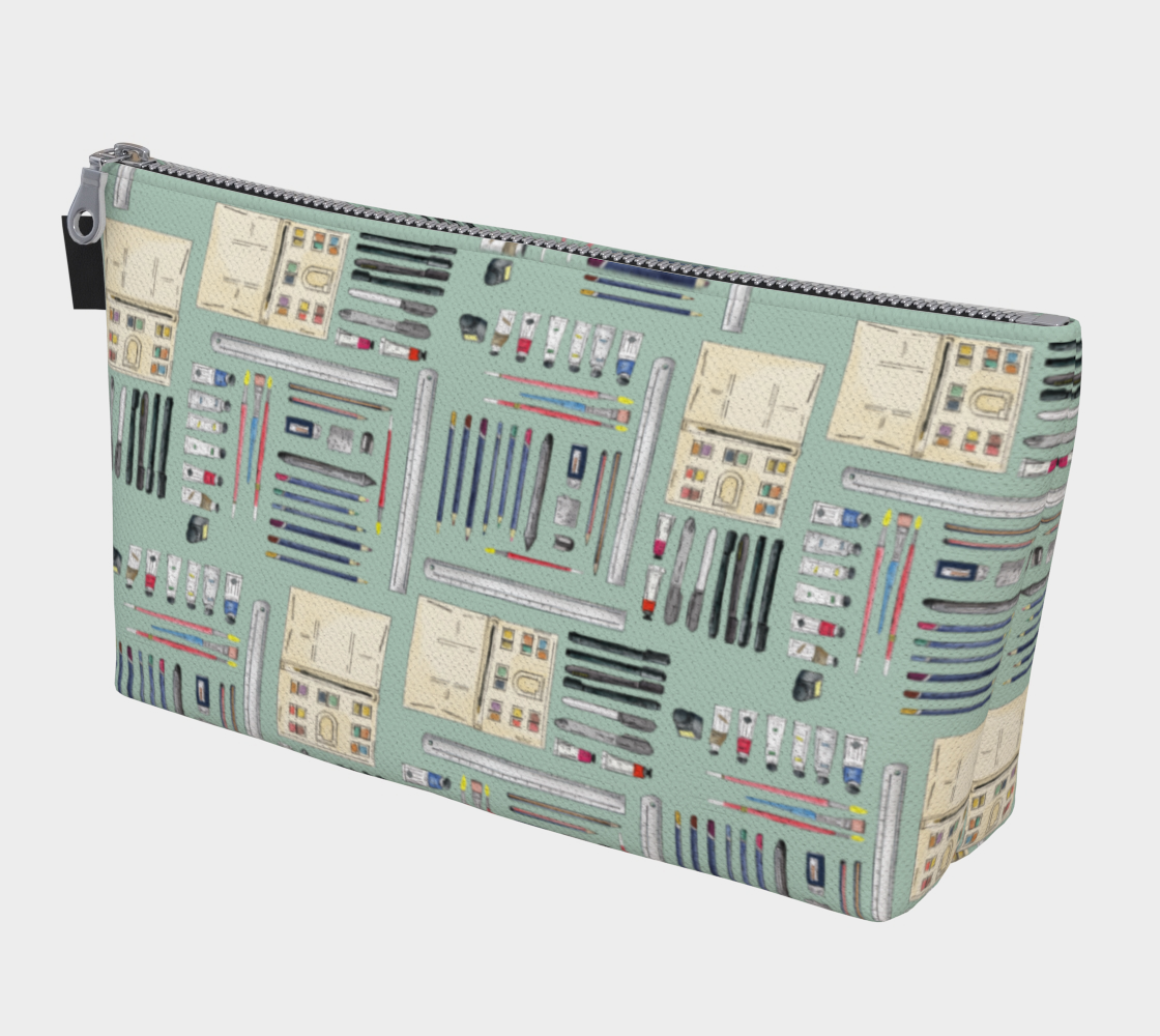 Art supplies on light sage background - makeup bag