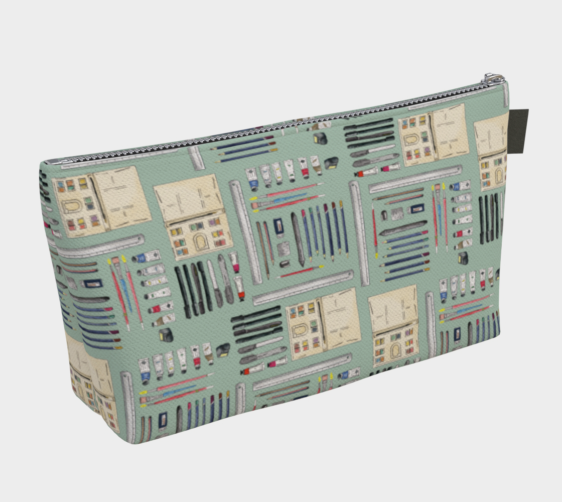 Art supplies on light sage background - makeup bag